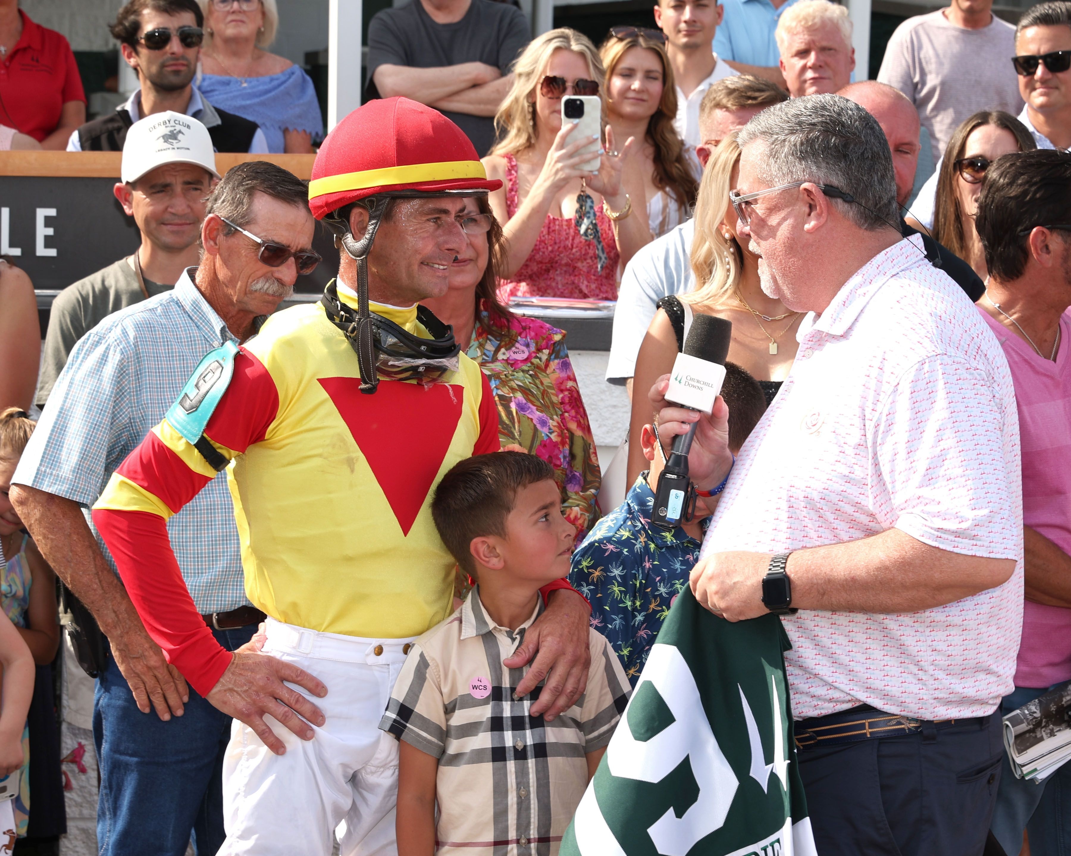 Darren Rogers presents Corey Lanerie with a saddle towel commemorating his 19 riding titles